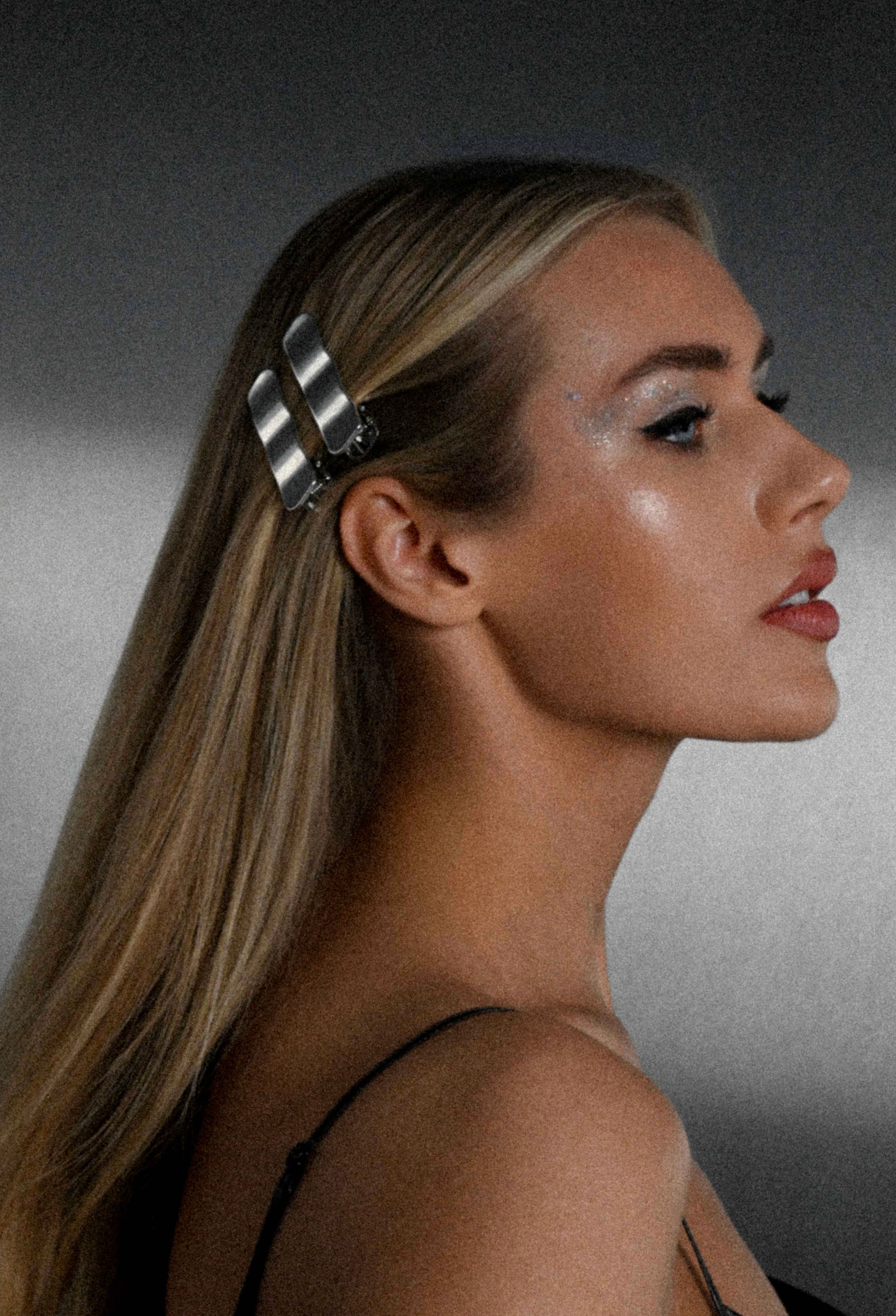 Woman with a hair clip on a gray background