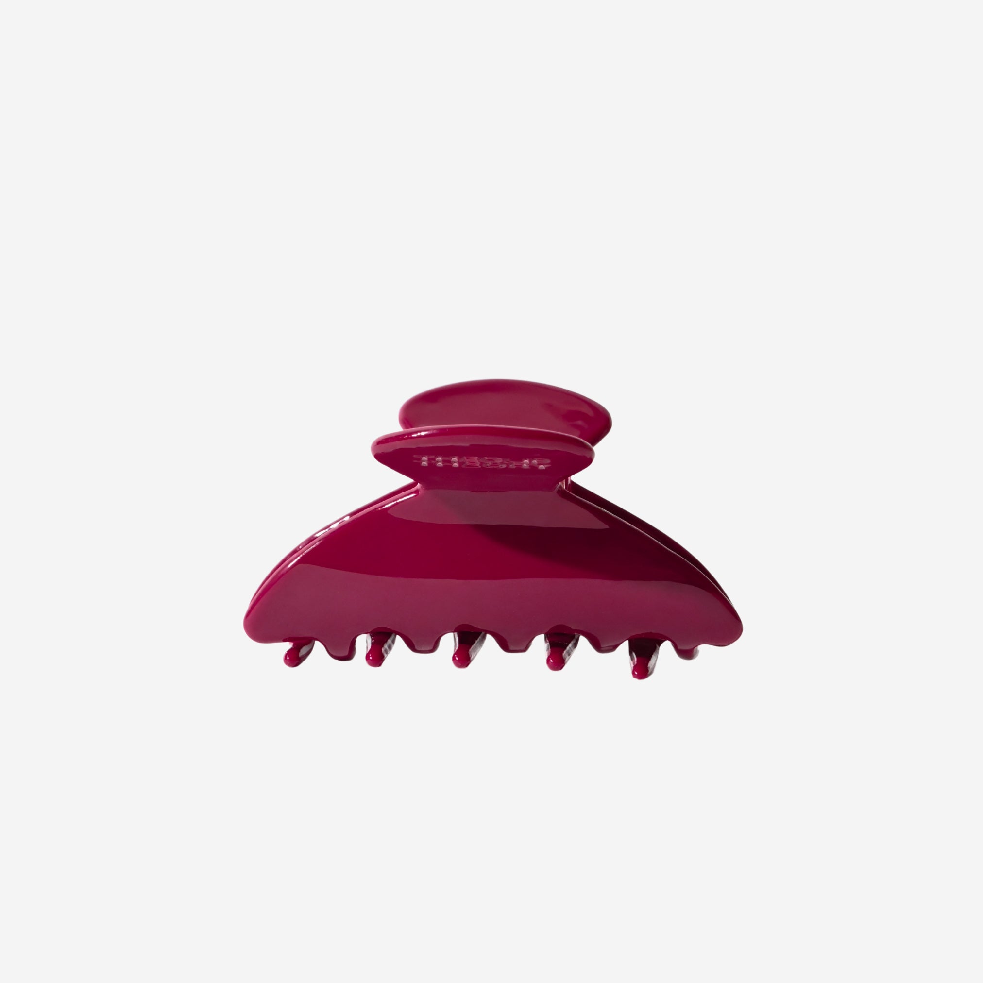 Red hair clip on a white background