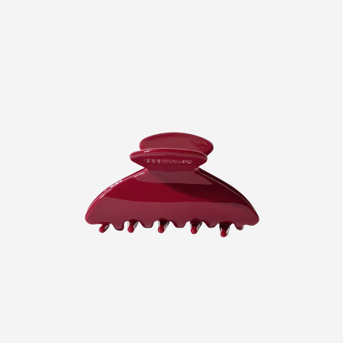 Red hair clip on a white background