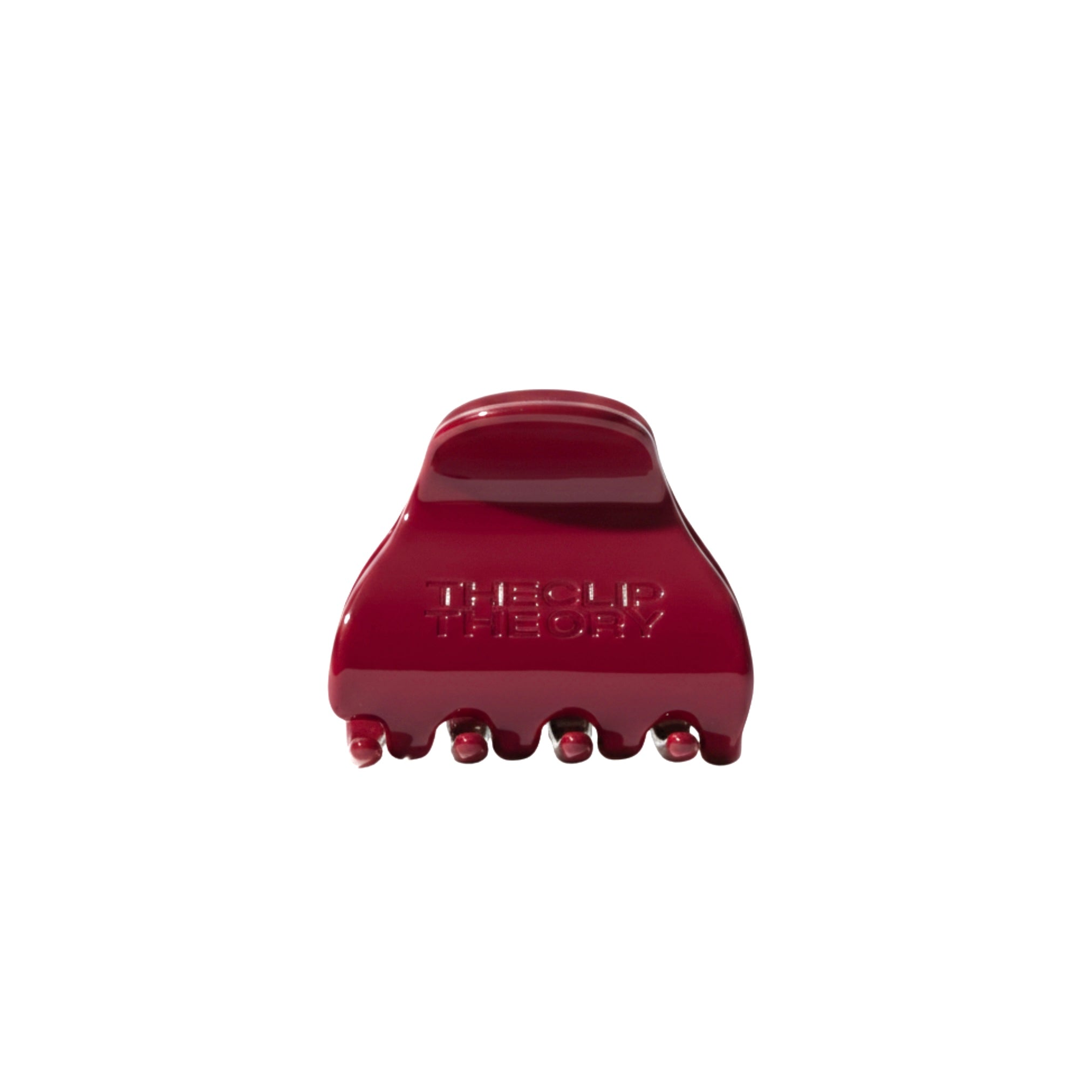 Red hair clip with 'The Clip Theory' branding on a white background