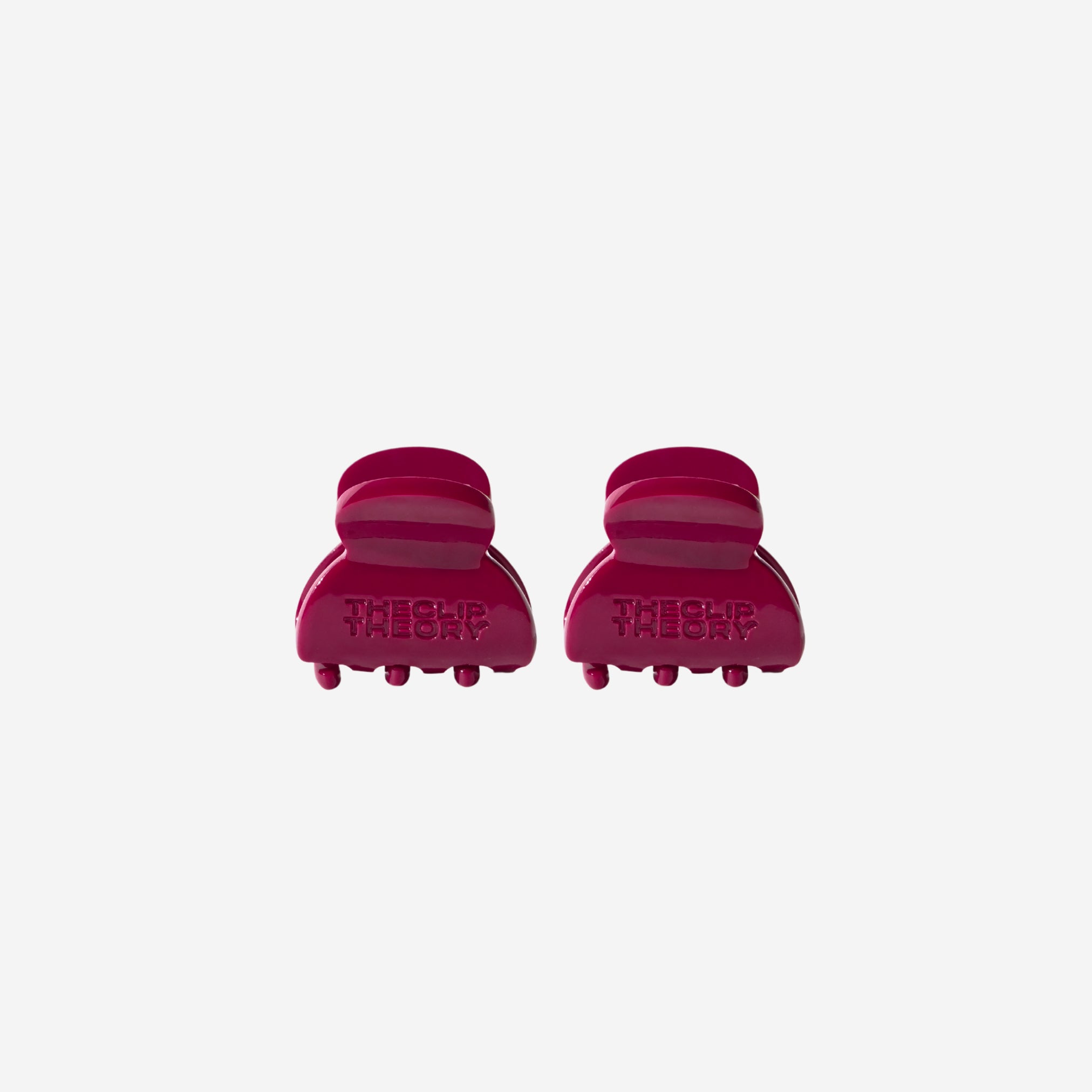 Two red hair clips on a white background