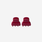 Two red hair clips on a white background